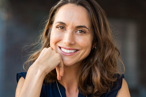 Image of a woman smiling after knowing her dental care cost is affordable, at Masci, Hale & Wilson Advanced Aesthetic and Restorative Dentistry in Montgomery, NY.