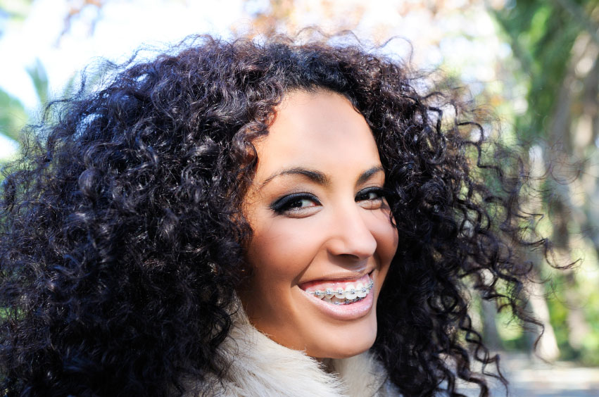 Black woman smiling with braces at Masci, Hale & Wilson Advanced Aesthetic and Restorative Dentistry in Montgomery, NY